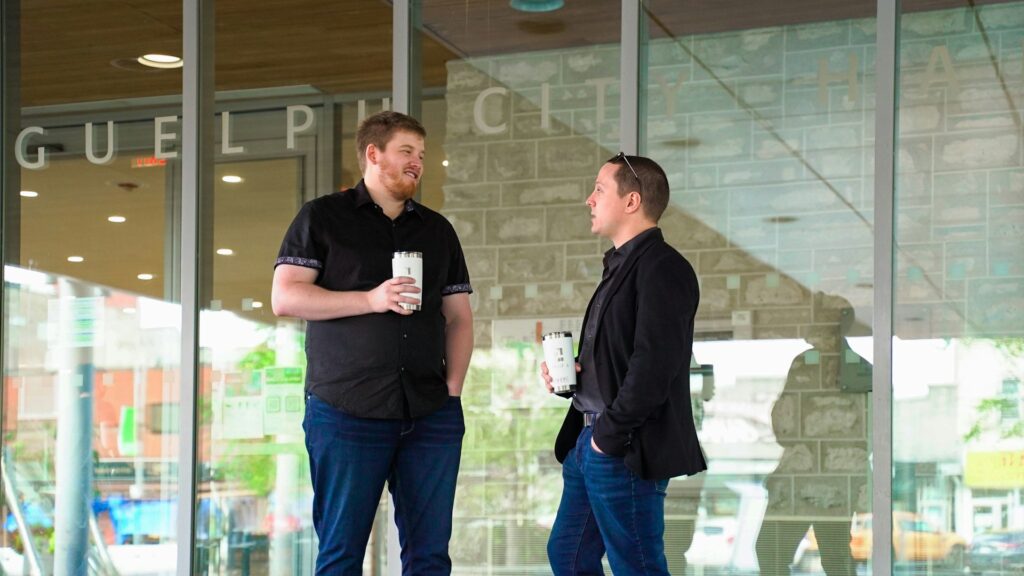 two men talking outside