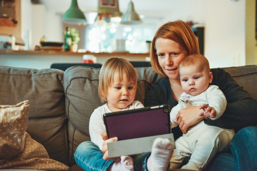 woman with two kids on couch