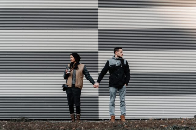 couple standing against a wall