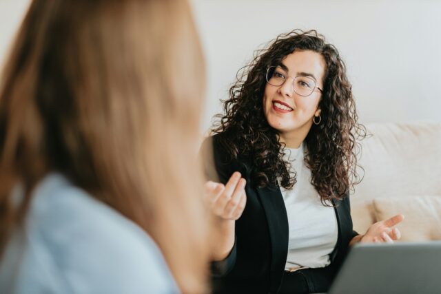 two women talking at work