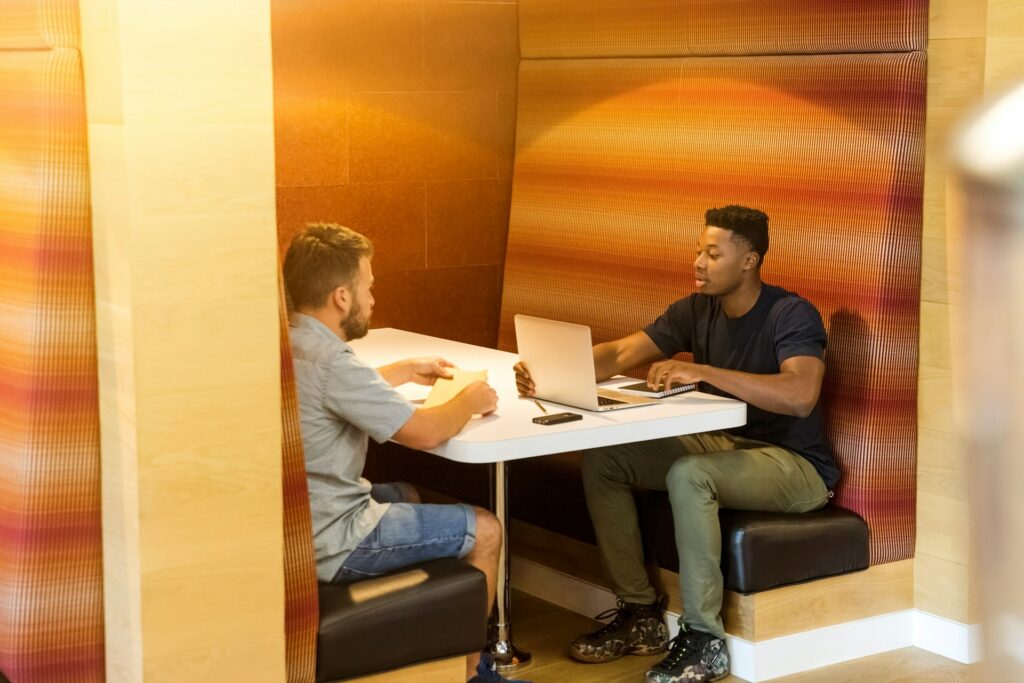 two men chatting in coworking space