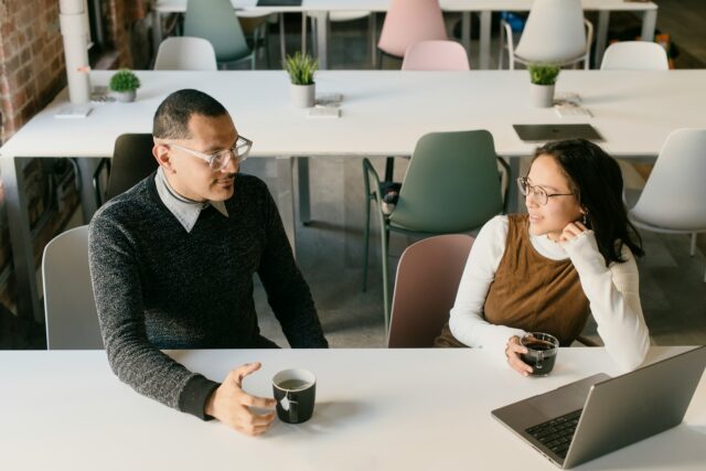 man and woman colleagues at table