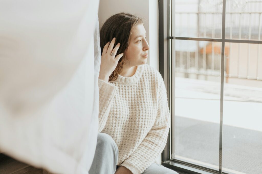 serious woman looking out window