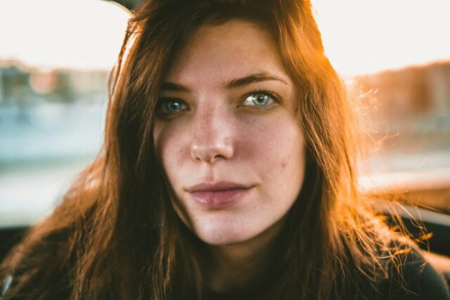 serious woman with red hair looking forward