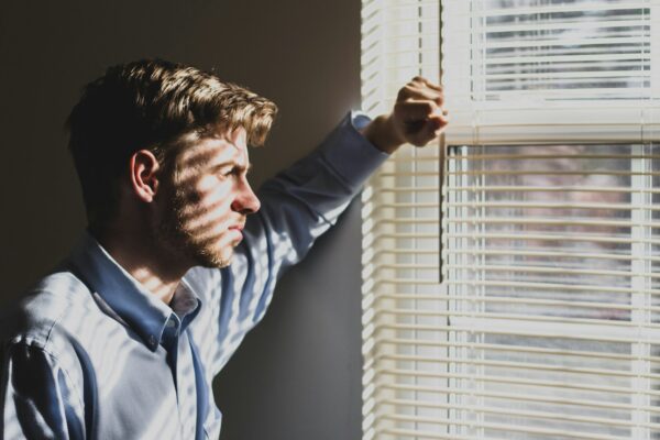 serious man looking out window