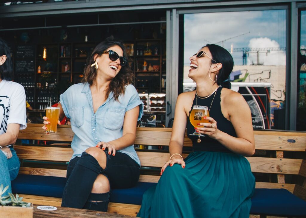 female friends enjoying beer outdoors